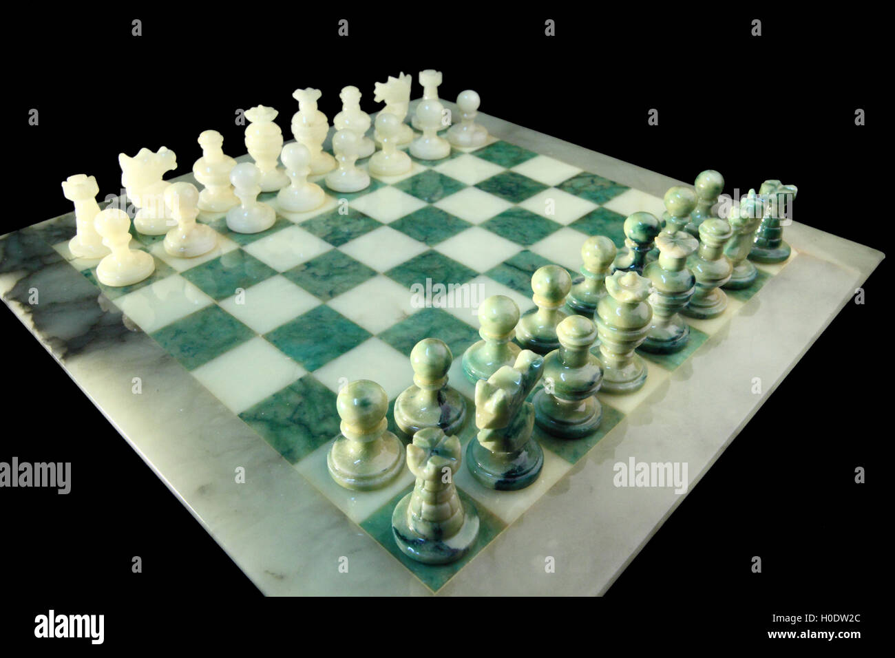 chessboard and alabaster chess on a black background Stock Photo - Alamy