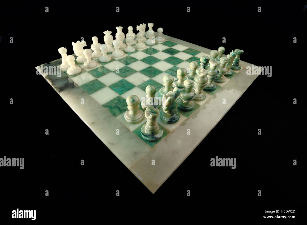 chessboard and alabaster chess on a black background Stock Photo - Alamy