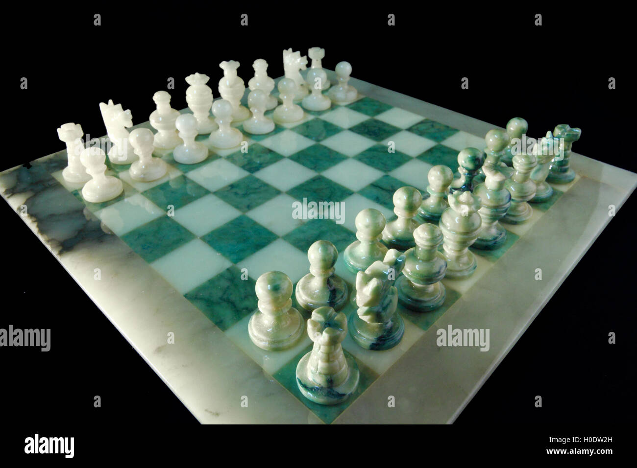 chessboard and alabaster chess on a black background Stock Photo - Alamy