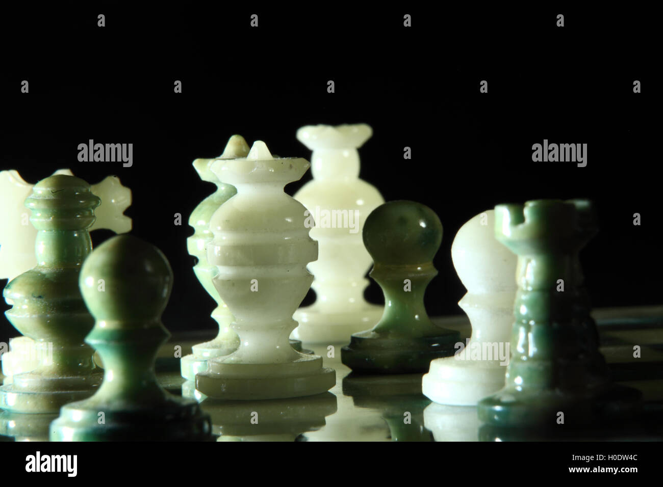 chessboard and alabaster chess on a black background Stock Photo - Alamy