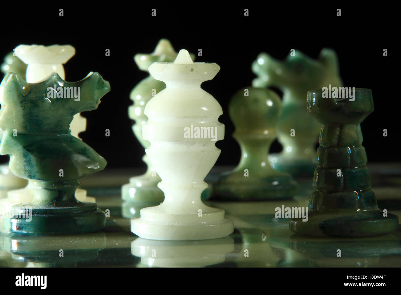 chessboard and alabaster chess on a black background Stock Photo - Alamy