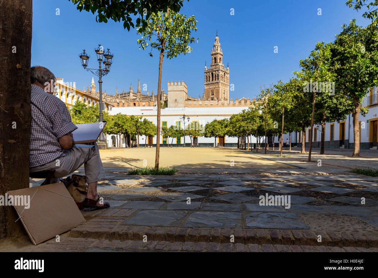 Elderly man painting Plaza del Patio de Banderas, Seville, Seville province, Andalusia, Spain Stock Photo