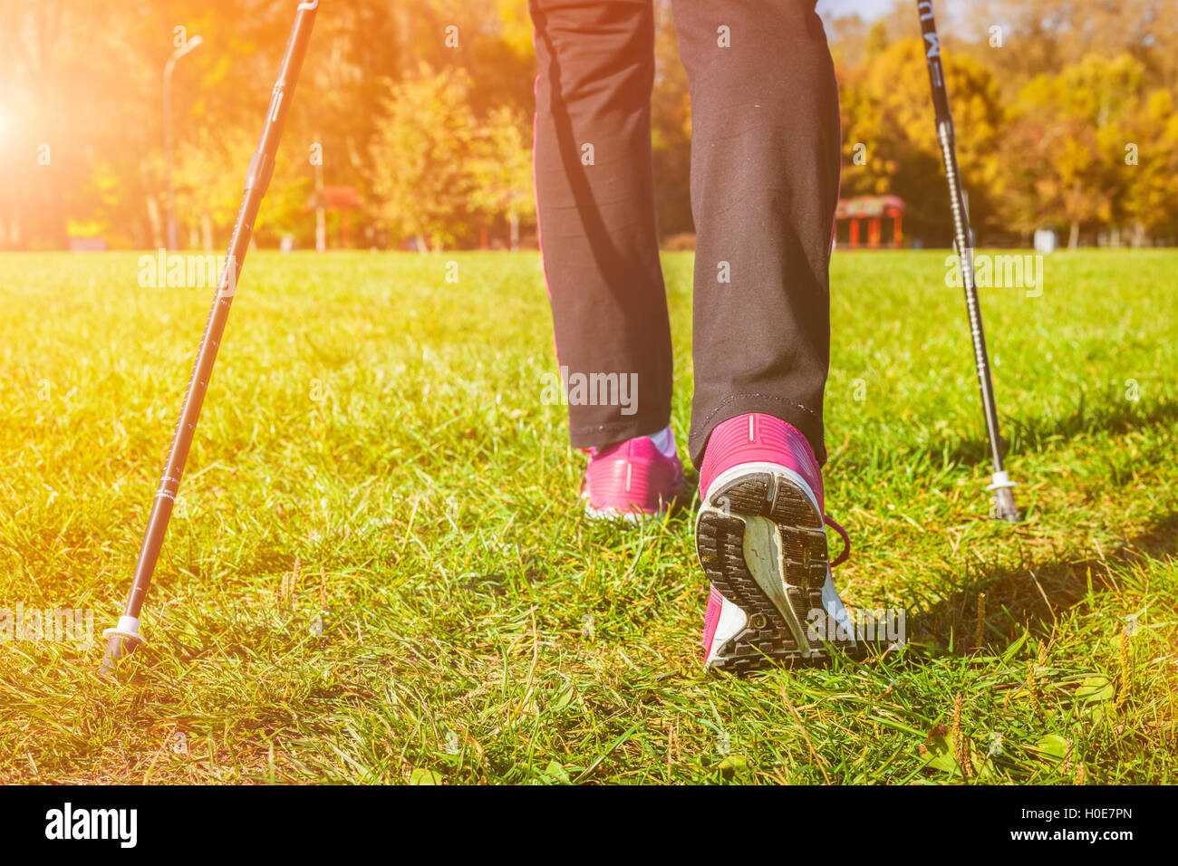 Woman nordic walking outdoors feet close up Stock Photo