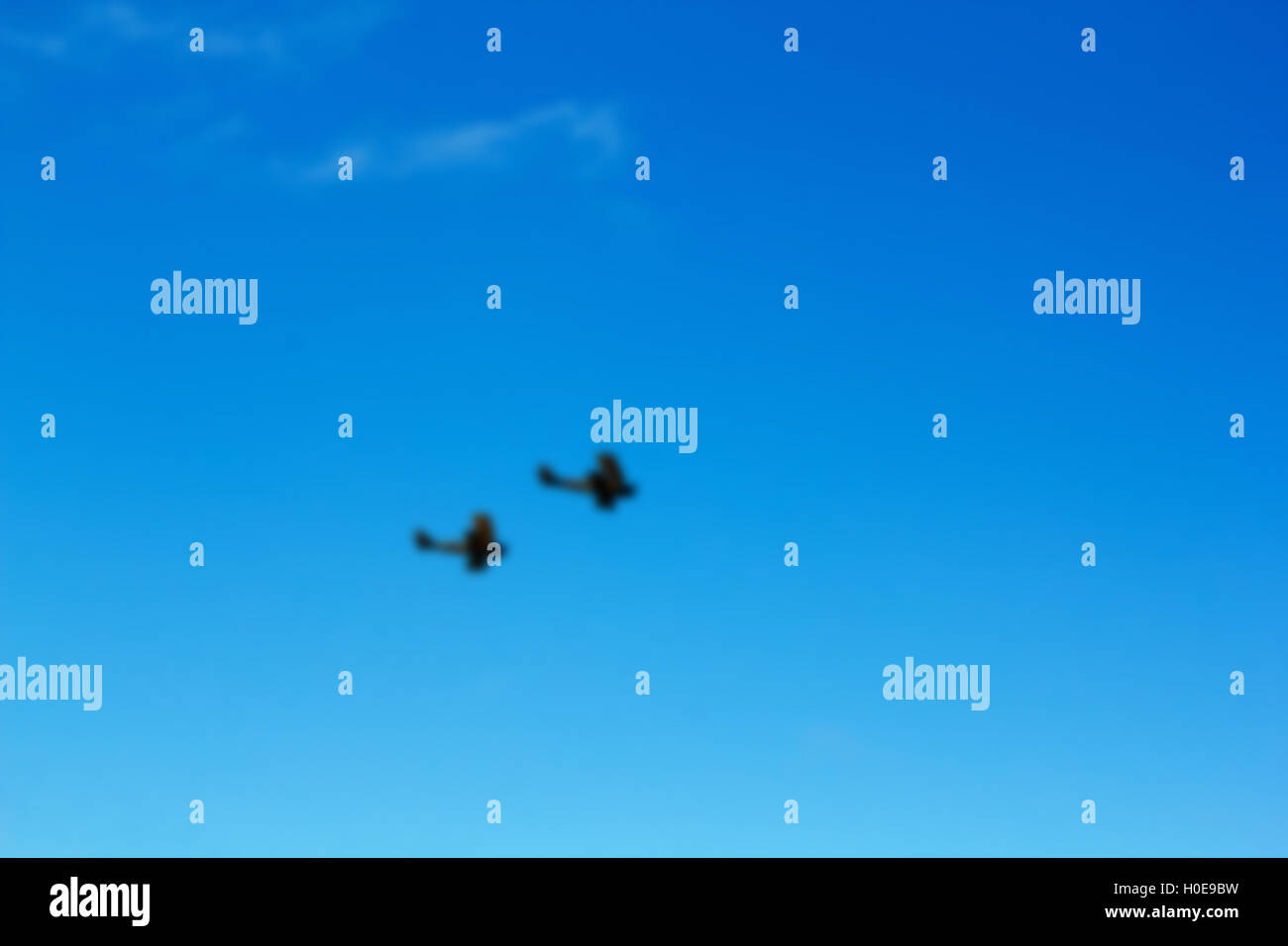 Pair of biplanes against a clear blue sky Out of focus. Stock Photo