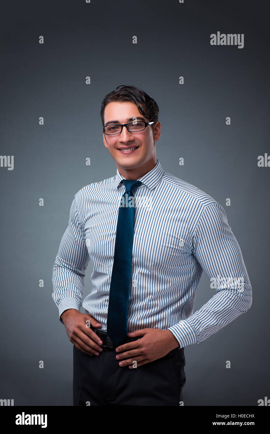 Handsome businessman against gray background Stock Photo - Alamy