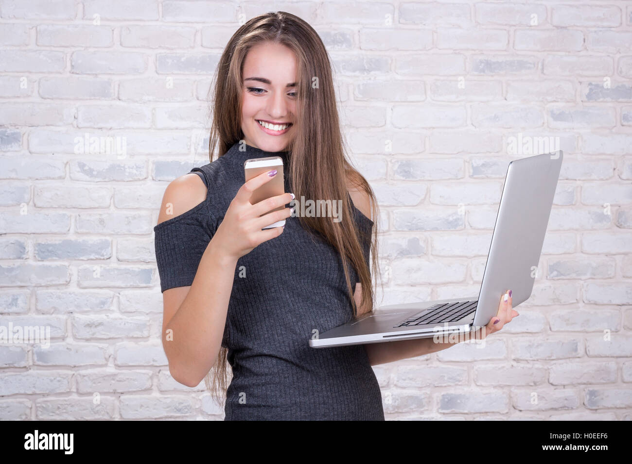 Young beautiful girl model with long hair imitates business lady, office manager or administrator with notebook and telephone Stock Photo