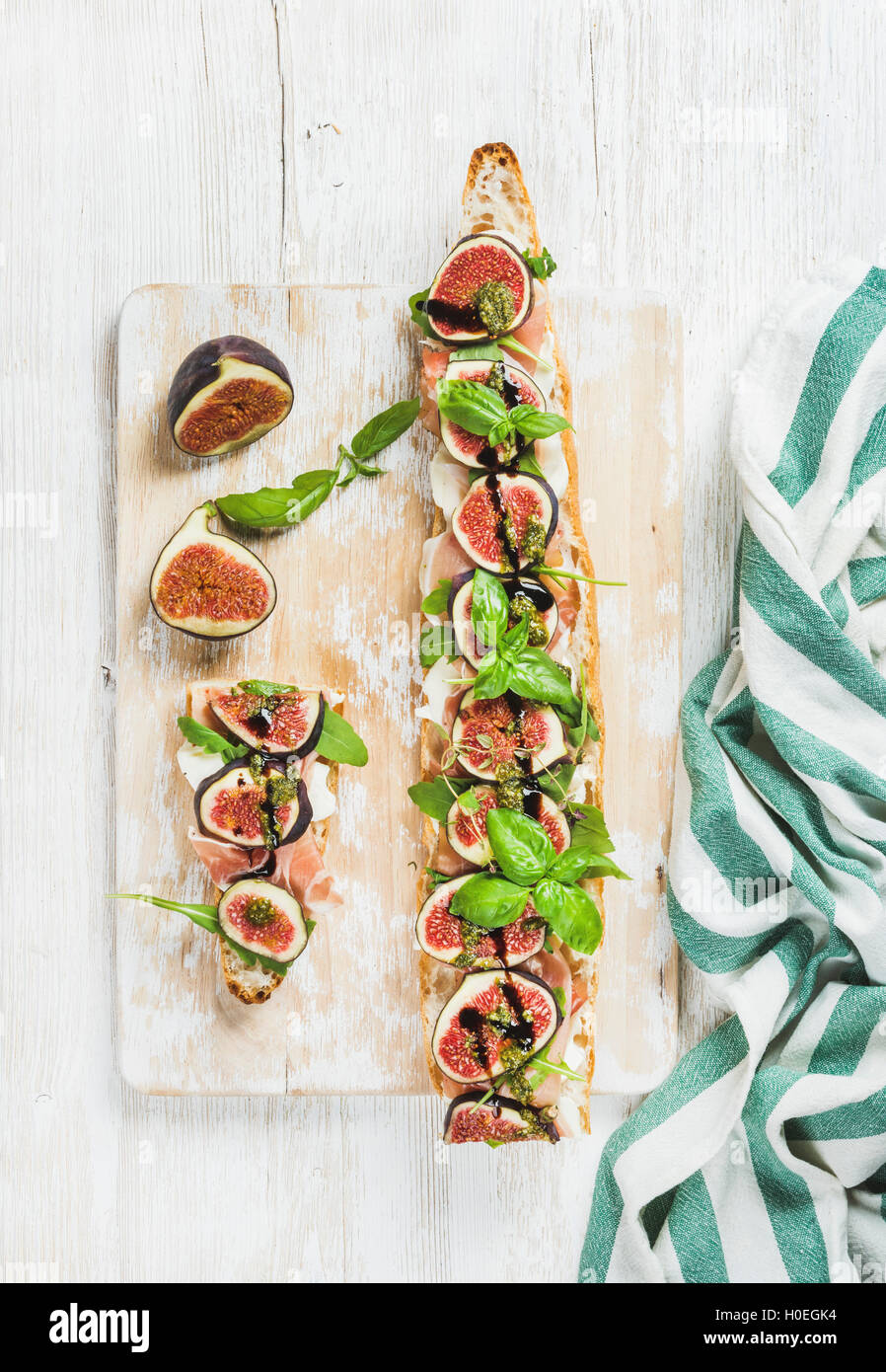 Long baguette sandwich with prosciutto meat, mozzarella cheese, fresh