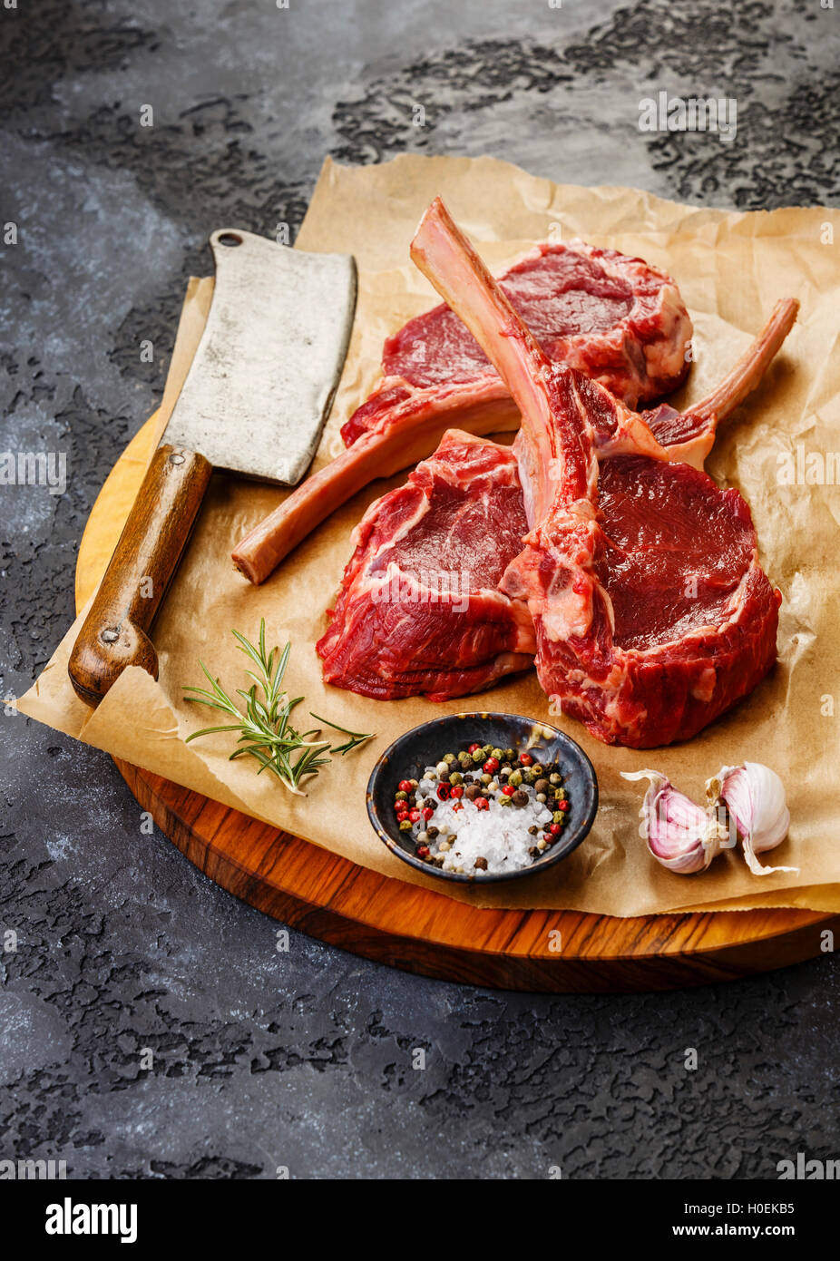 Raw fresh meat Veal ribs Steak on bone and Meat cleaver on dark background Stock Photo