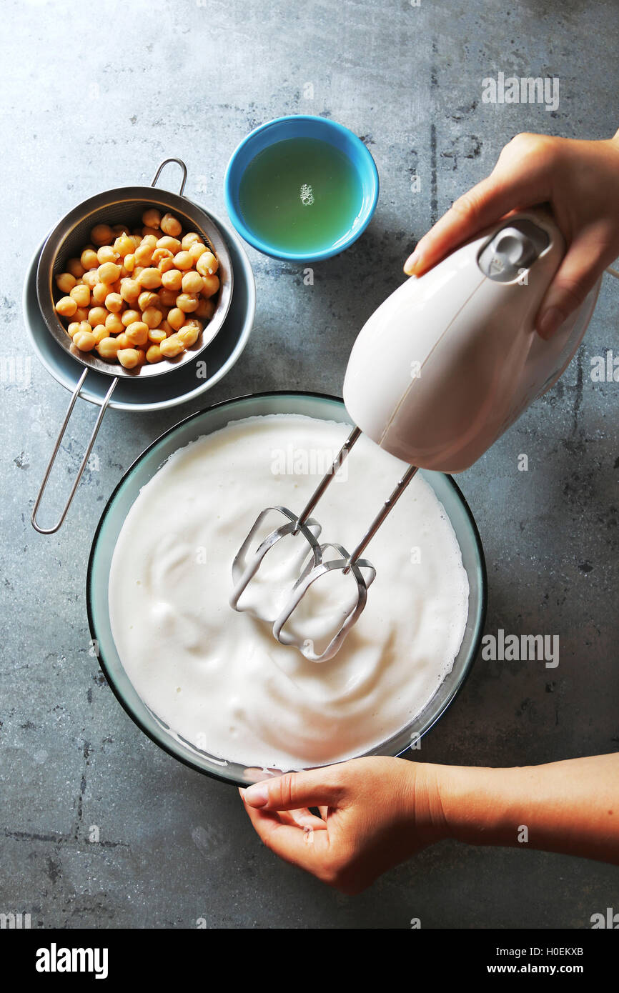 Making vegan whipped topping with aquafaba.Top view Stock Photo