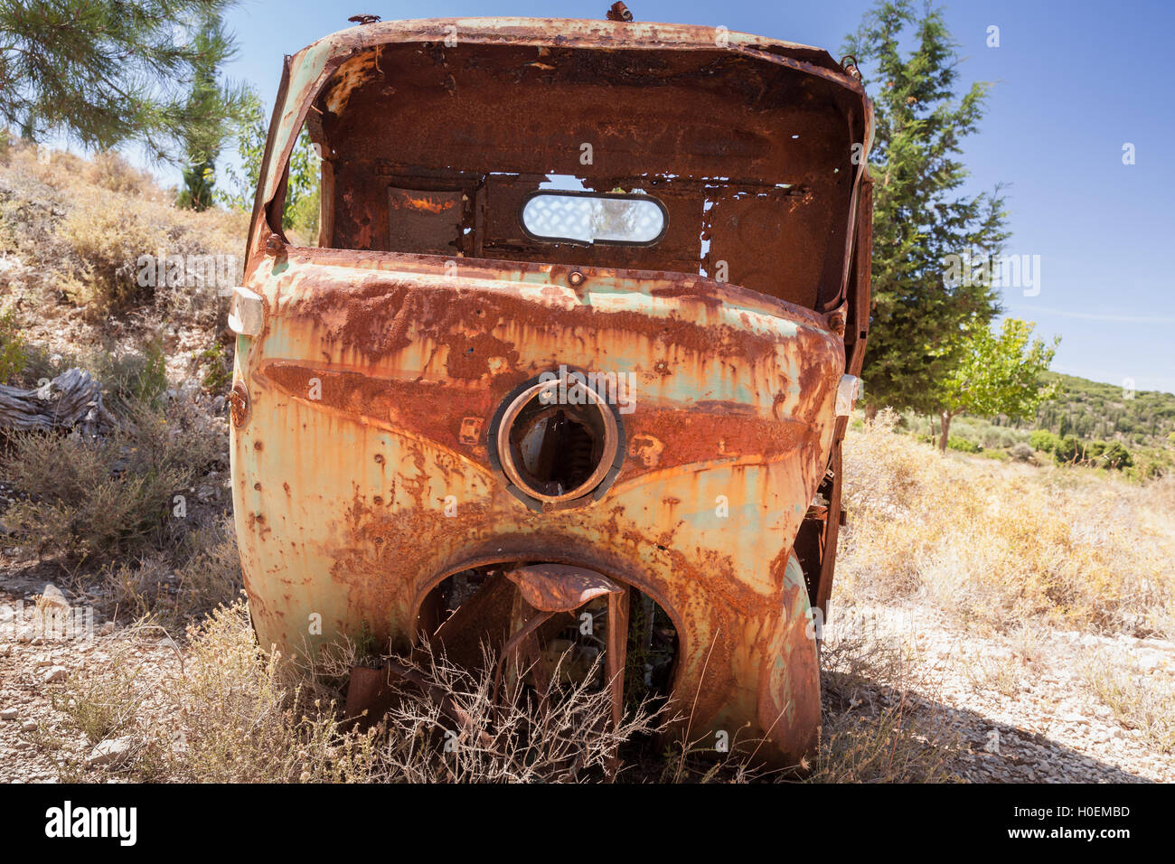 Abandoned rusted body of three-wheeled light commercial vehicle Stock Photo