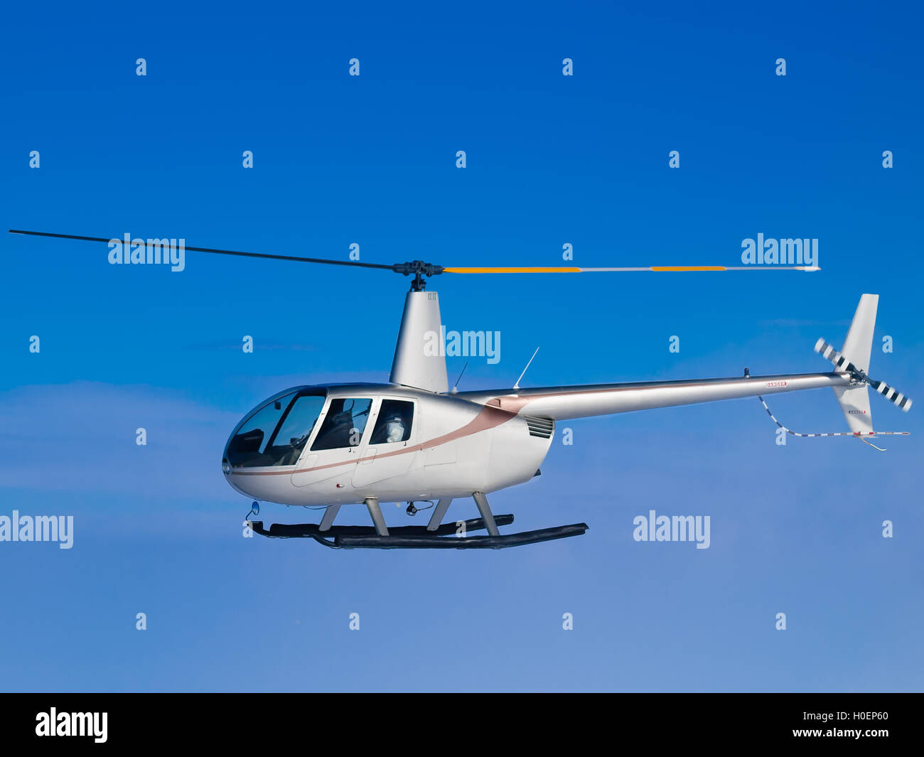 Helicopter flying in blue sky side view Stock Photo