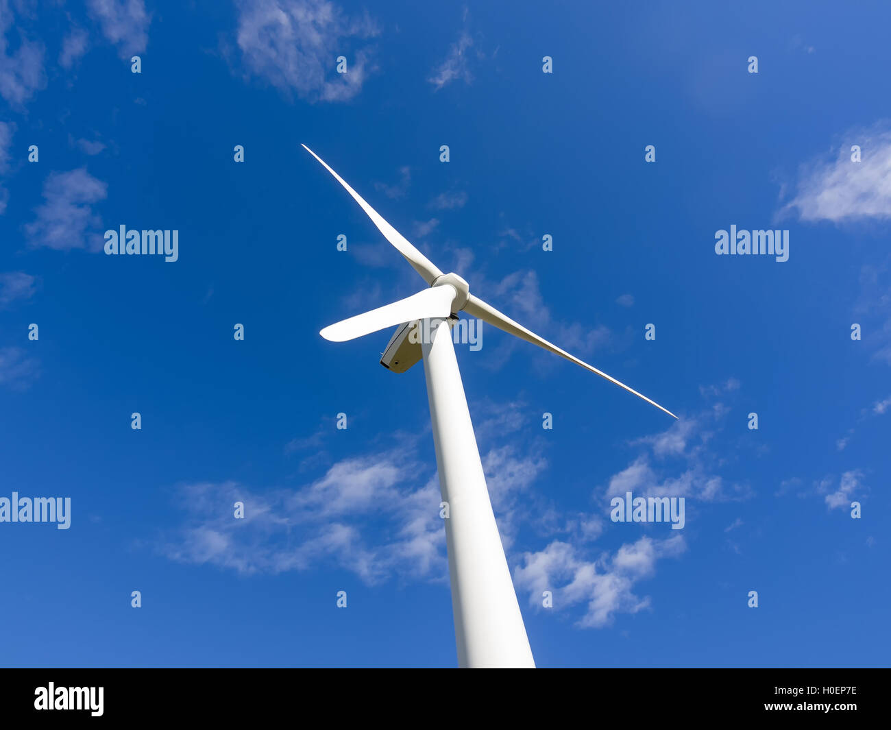 Single wind turbine stopped in blue sky Stock Photo