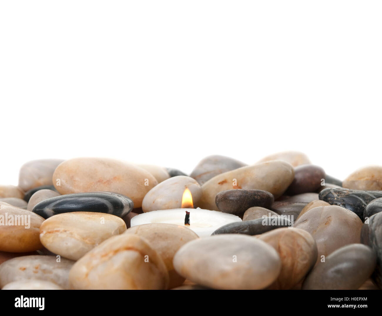 candle in stones isolated on white background Stock Photo Alamy