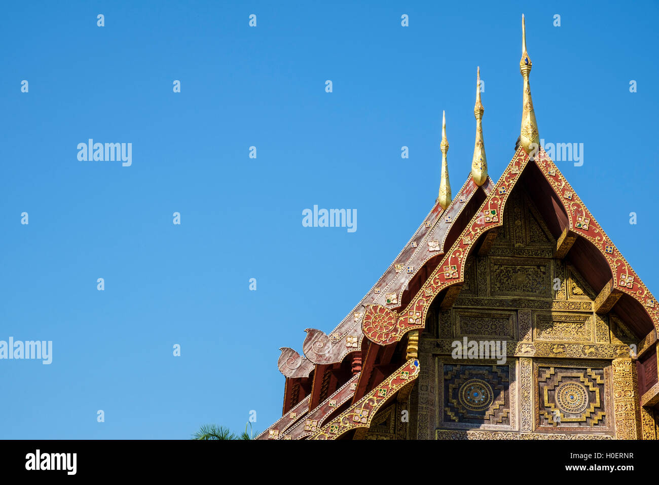 Lanna-style three-tier roof with chofa and carved wood pediment of Wat Phra Sing, Chiang Mai, Chiang Mai Province, Thailand. Stock Photo
