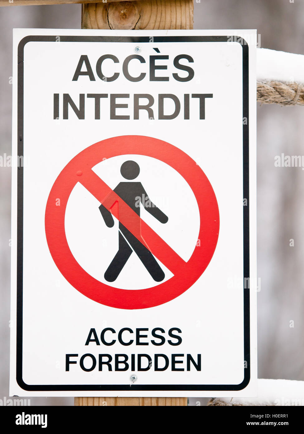Bilingual access forbiden sign on post in winter Stock Photo