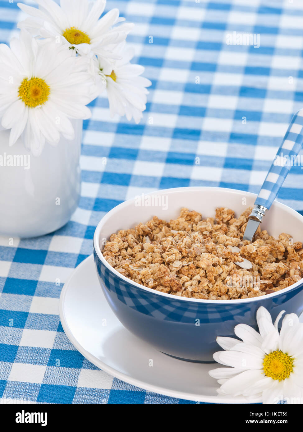 Breakfast cereal  on the  table with milk and flowers Stock Photo