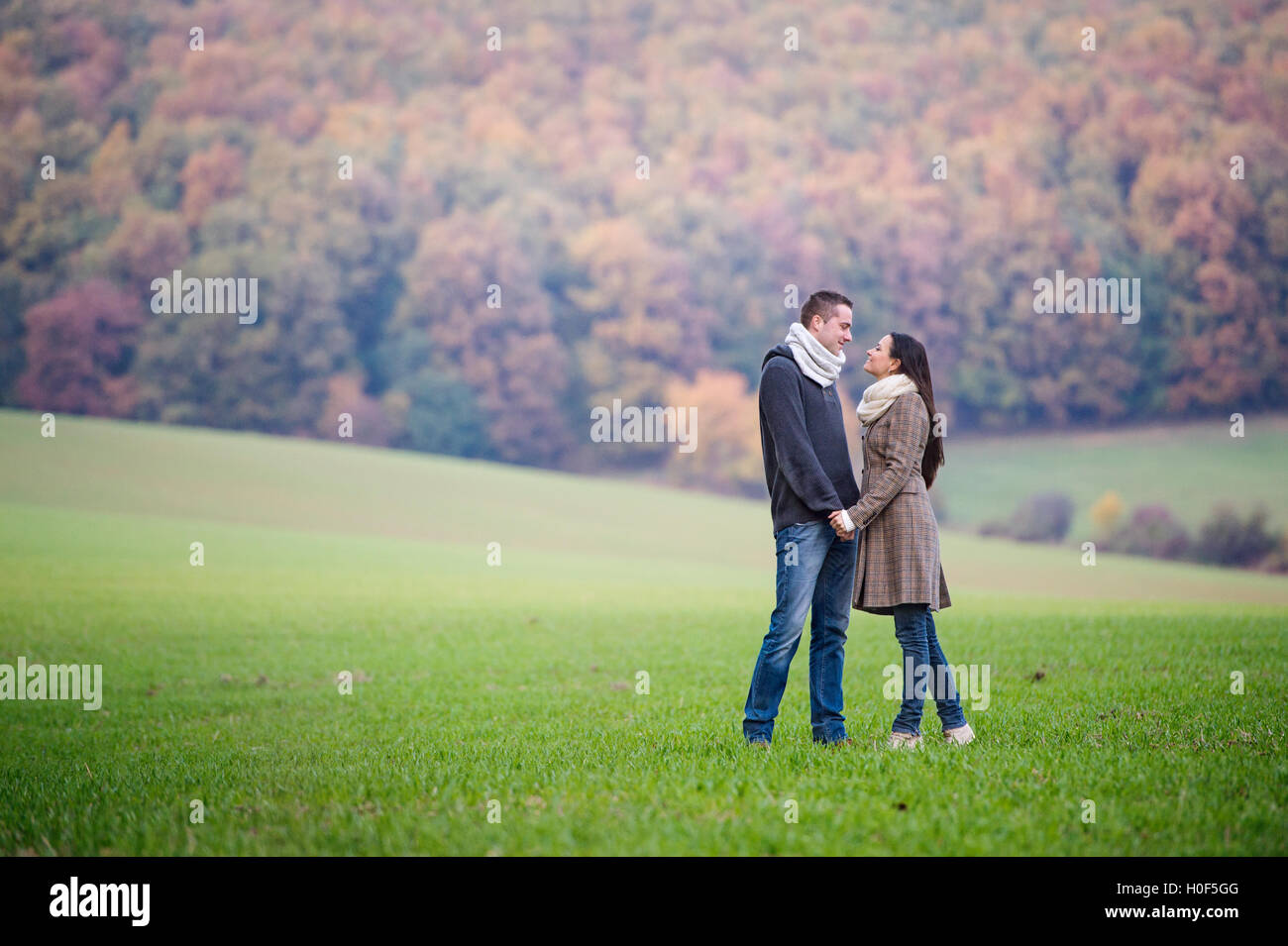 Beautiful young couple on a walk. Colorful autumn nature Stock Photo ...
