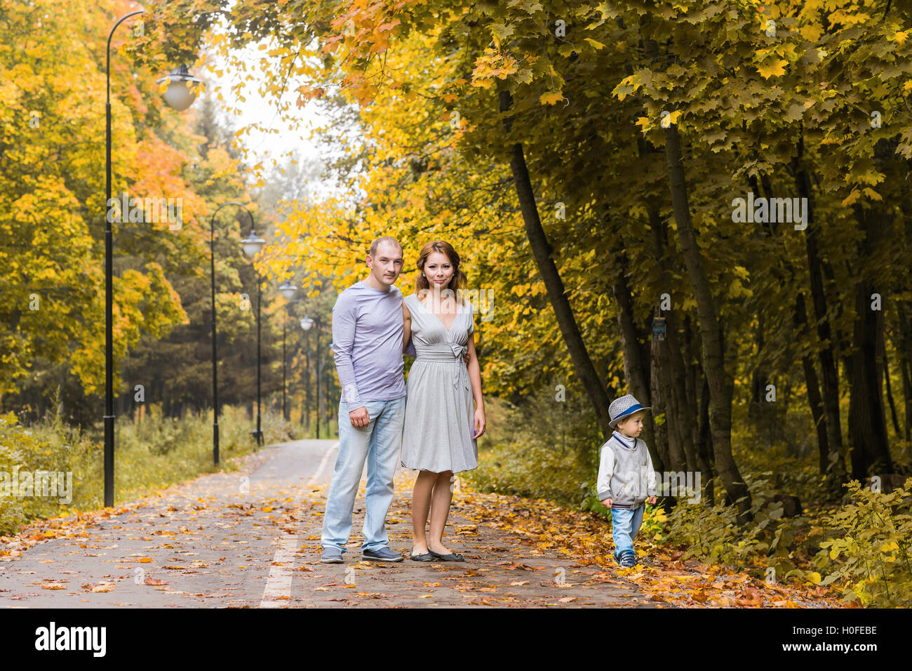 friendly family walking in the park in autumn together Stock Photo - Alamy