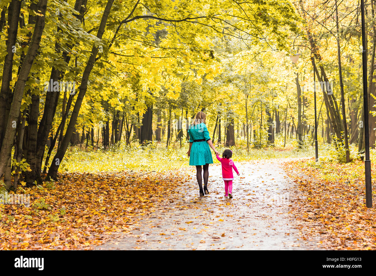 Mother with her baby. Mom and daughter in an autumn park Stock Photo ...