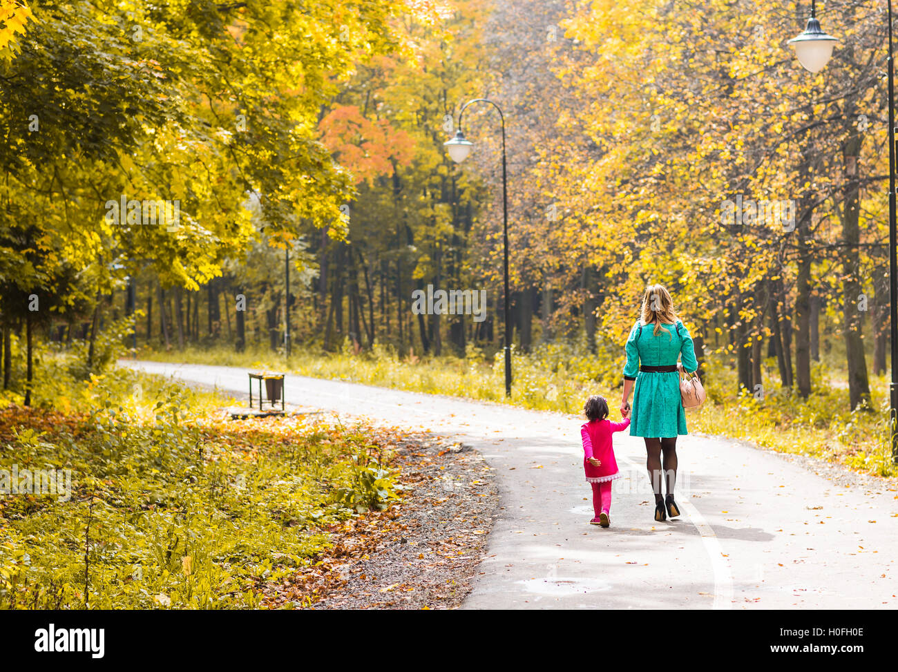 Mother with her baby. Mom and daughter in an autumn park Stock Photo ...