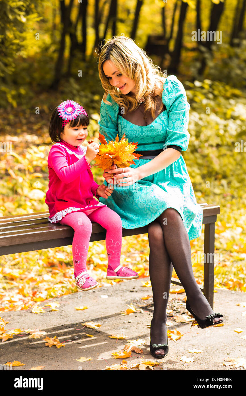 Young mother and her toddler girl have fun in autumn Stock Photo - Alamy