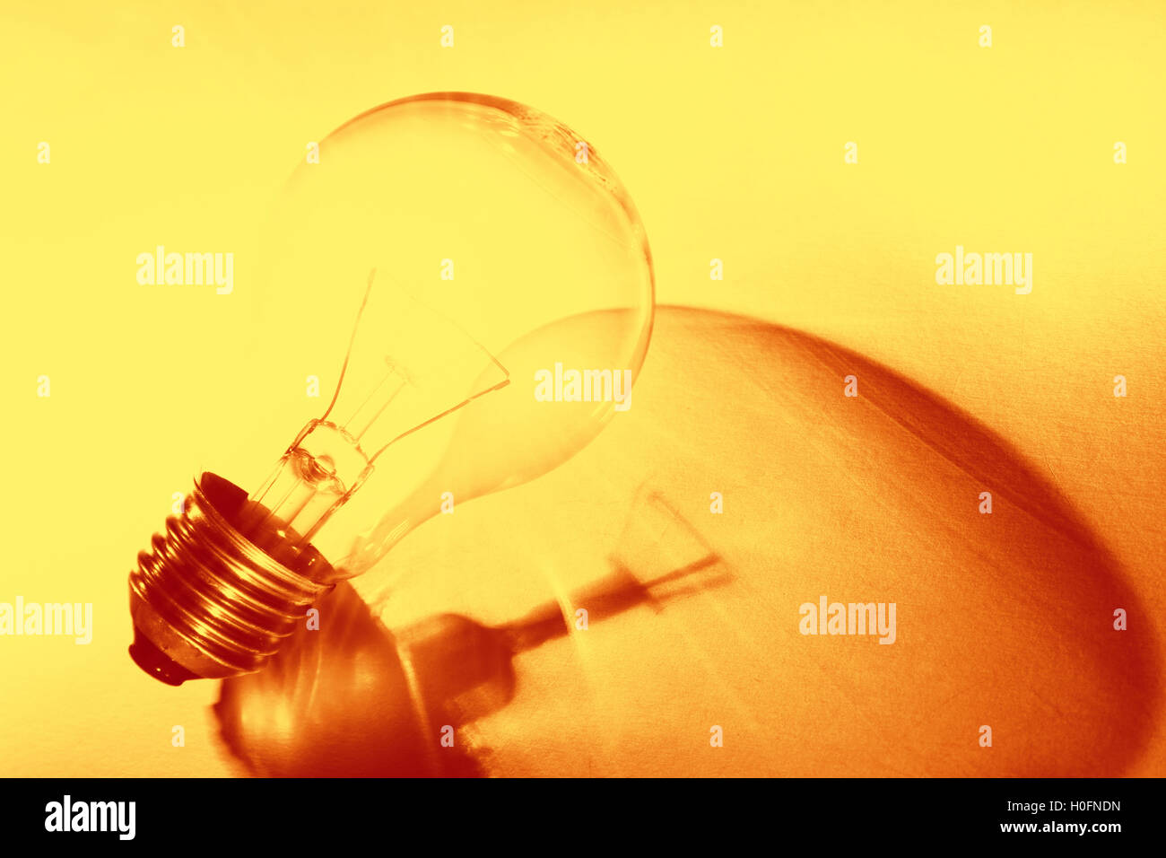 Light bulb on yellow background Stock Photo - Alamy