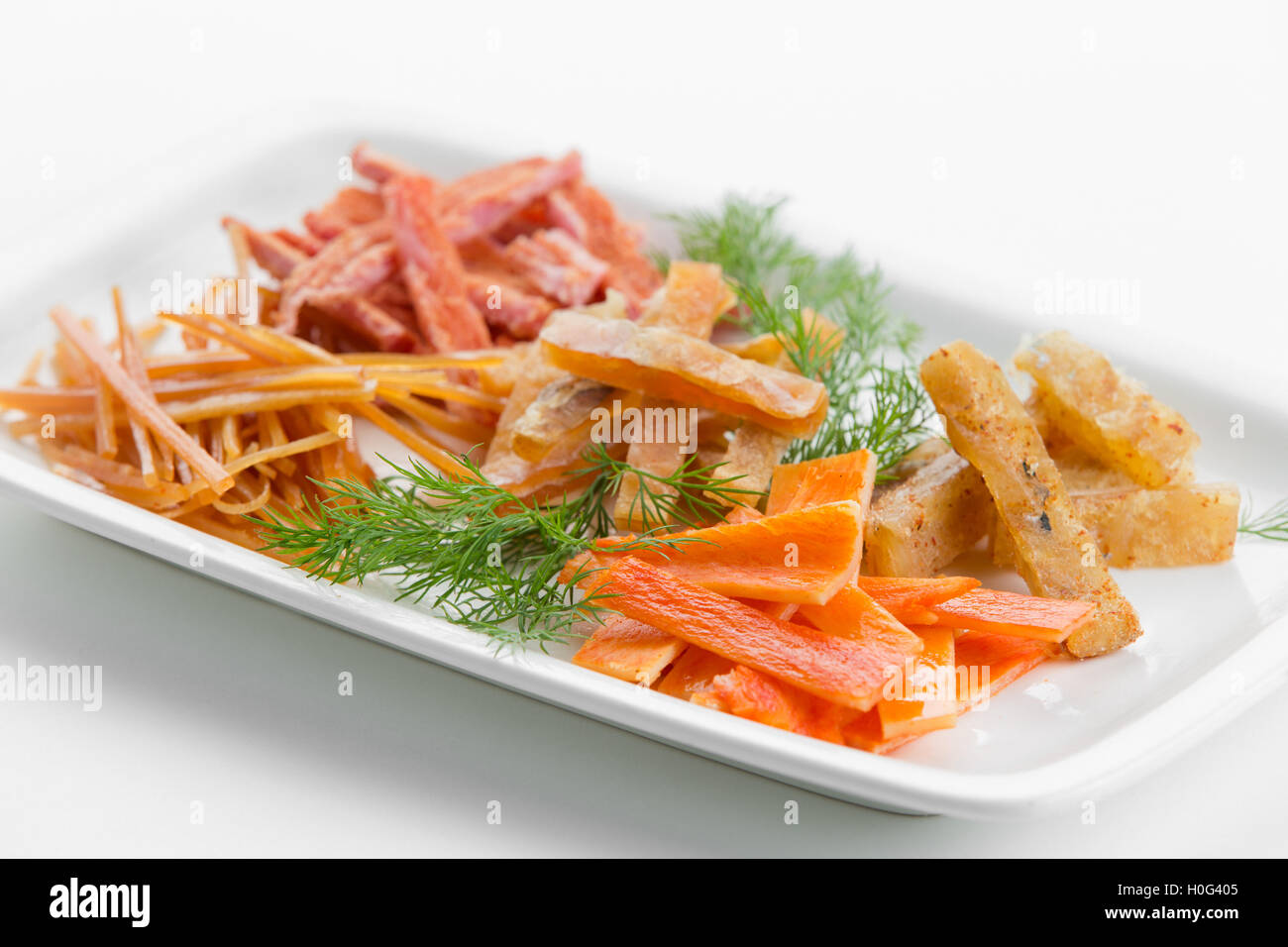 Fried fish platz with cumin and herbs on white plate Stock Photo