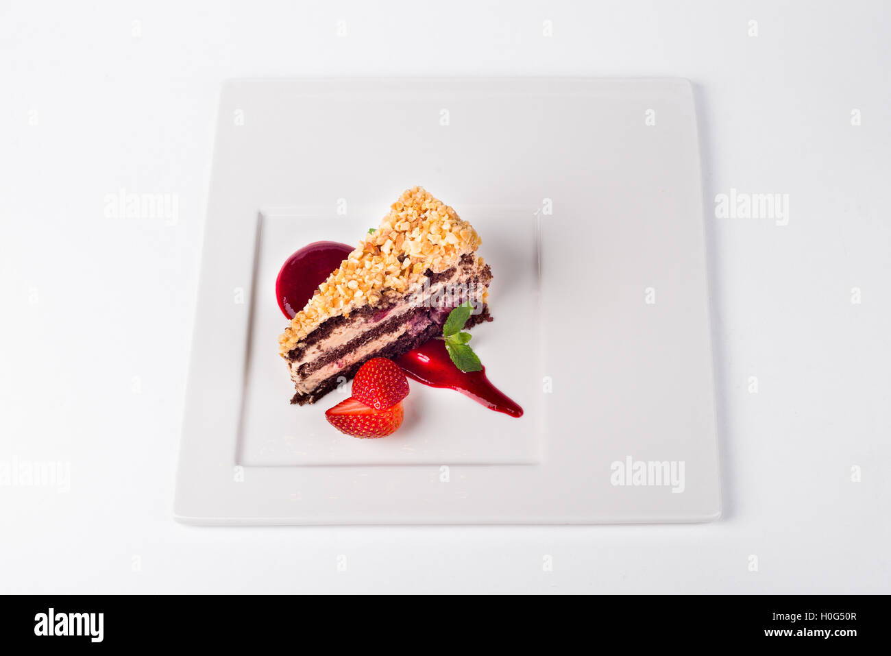 Chocolate cherry cake with strawberry on white plate background Stock ...