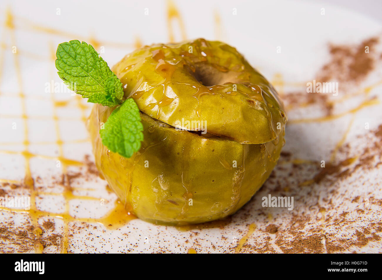 Baked apple with honey, nuts and cinnamon Stock Photo Alamy