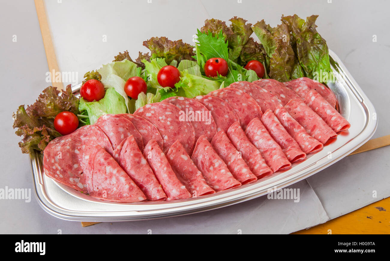 Soft salami platter of ham bacon with tomatoes and lettuce in lunch box