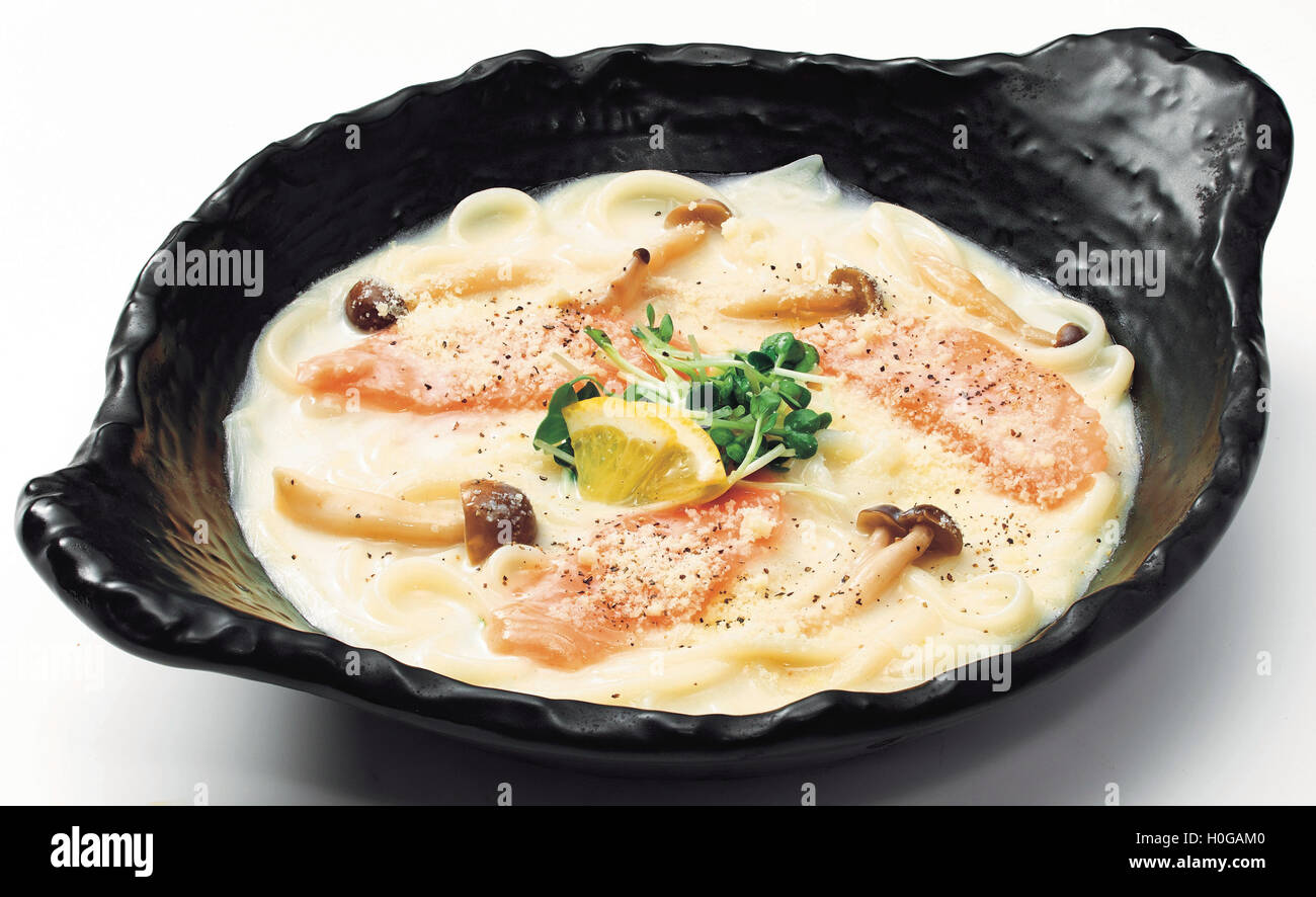 Japanese Udon noodle with salmon, mushroom, lemon and sprout in black