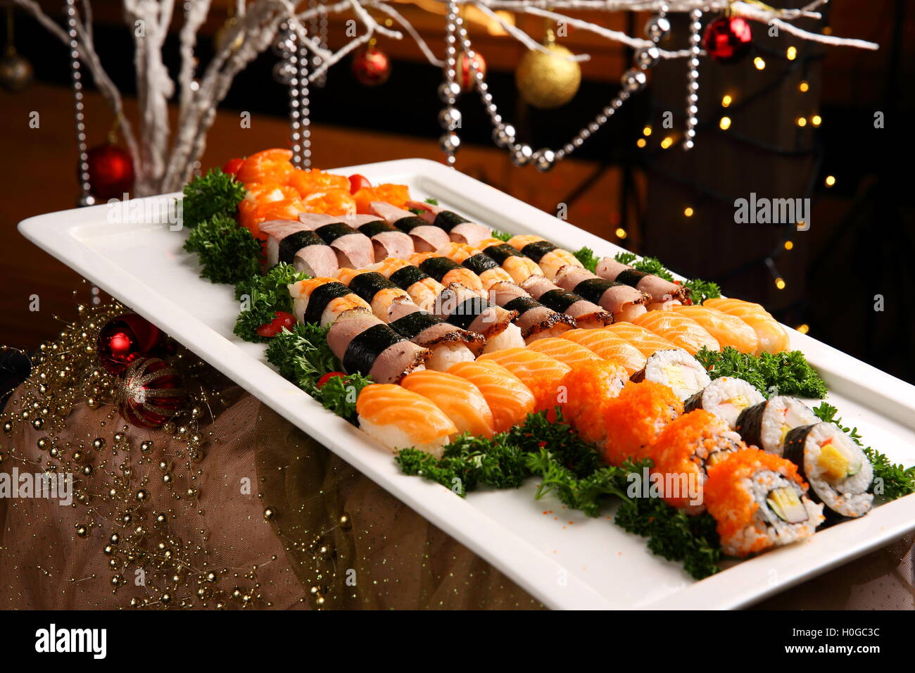 Freshly prepared sushi spread with kimbap and salmon on big white