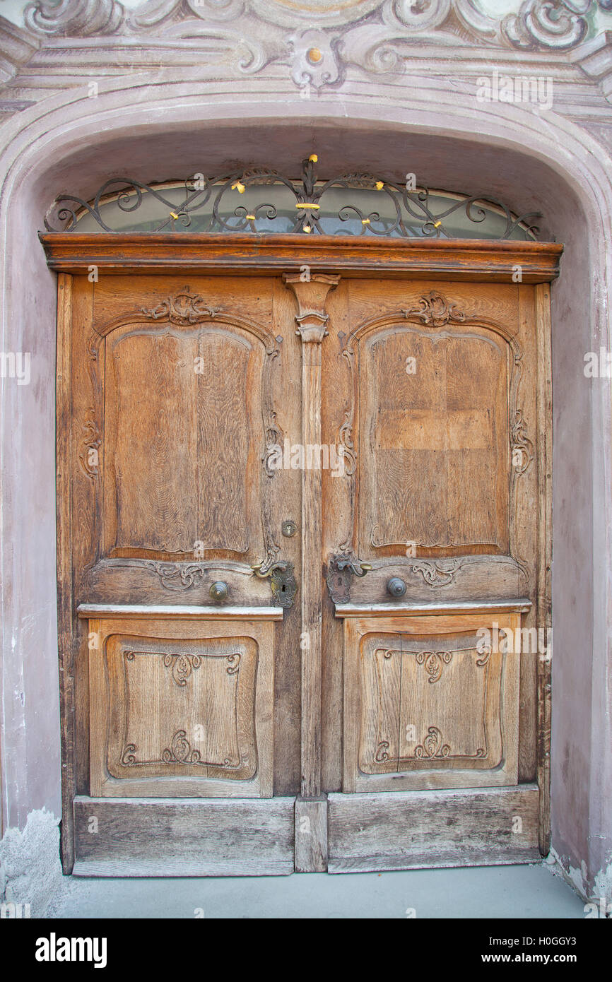 Old closed wooden door with stone frame Stock Photo
