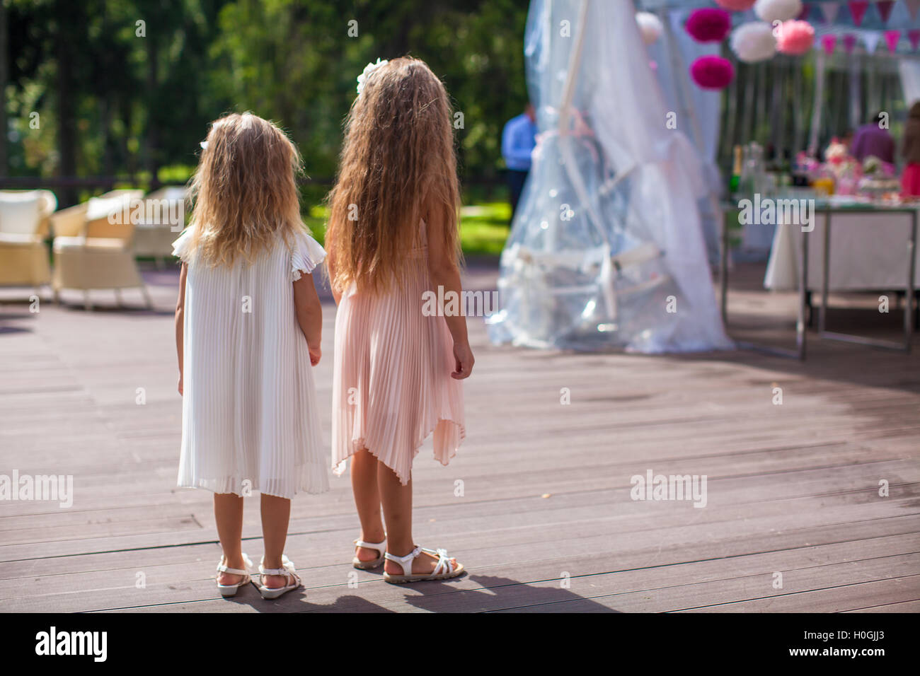 Two cute little girls in beautiful dresses on the wedding ceremony ...