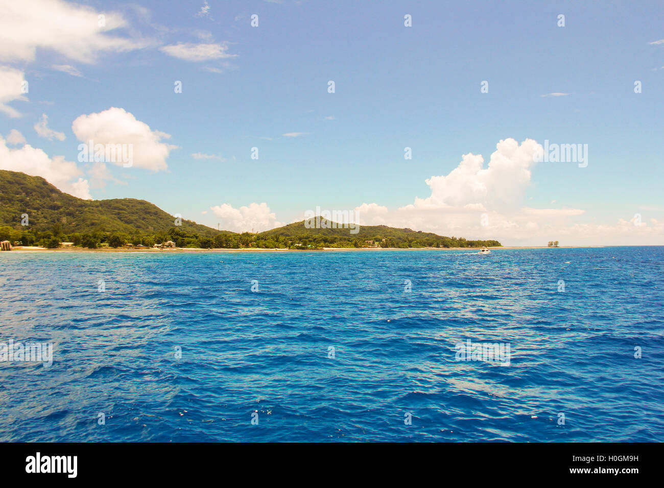 Waves from boats and view of the Mahe island Stock Photo - Alamy