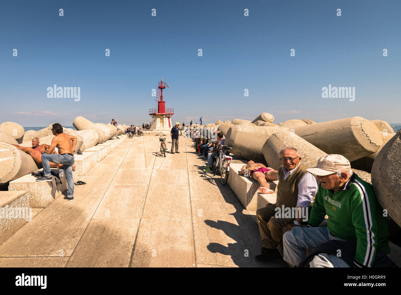 Sottomarina, Italy - May 20, 2016: The dam lighthouse in Sottomarina (Chioggia, Italy) is a meeting place for the local communit Stock Photo