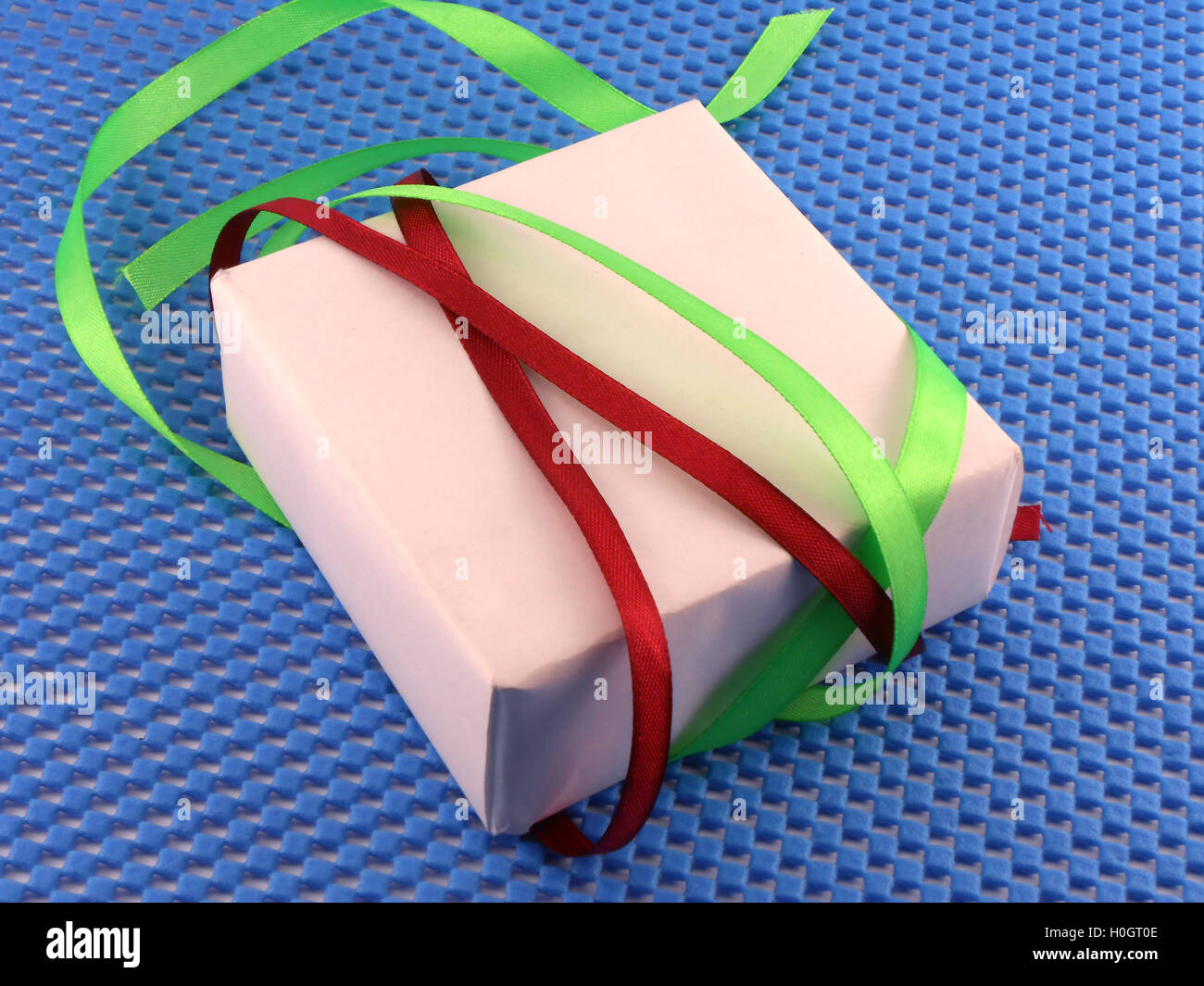 White gift box with red ribbon bow Stock Photo - Alamy