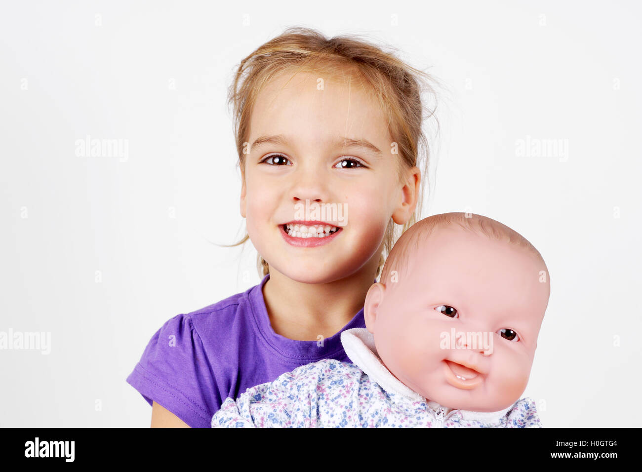 Little girl playing with doll Stock Photo - Alamy