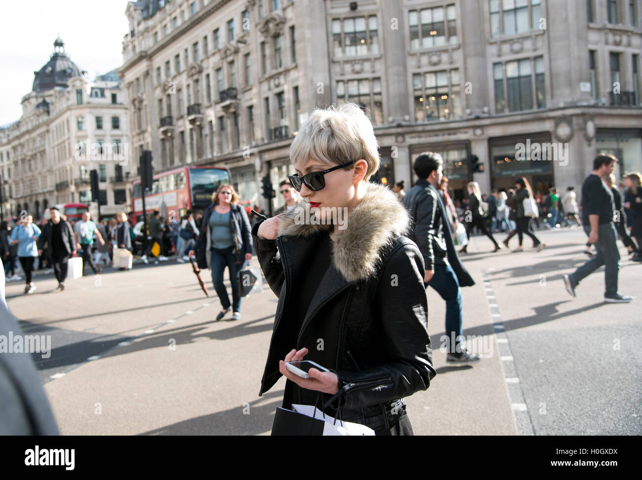 woman sunglasses crossing road diagonal shopping Stock Photo