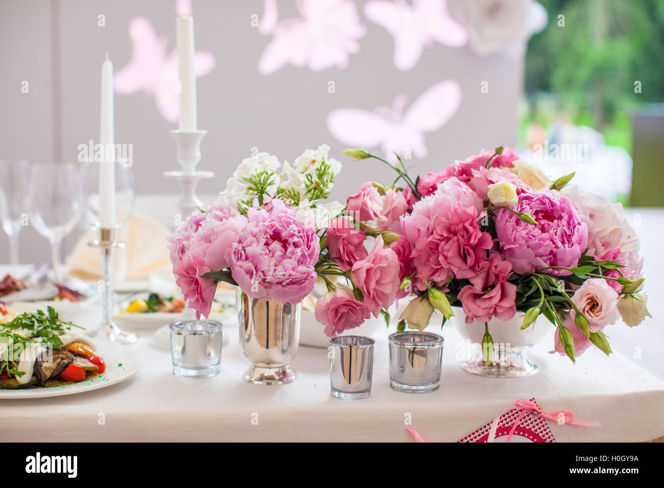 Beautiful bright bouquet of peony on the wedding table in vase Stock Photo