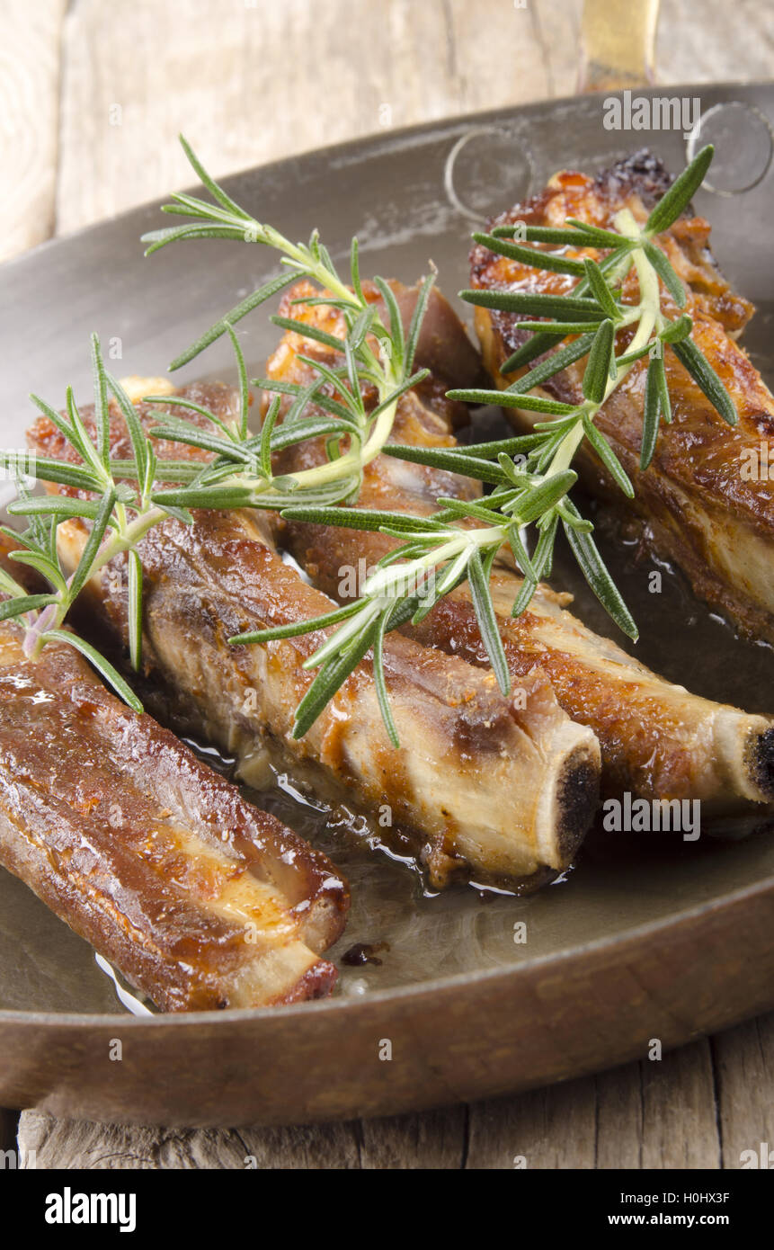 spare ribs with rosemary in a pan Stock Photo