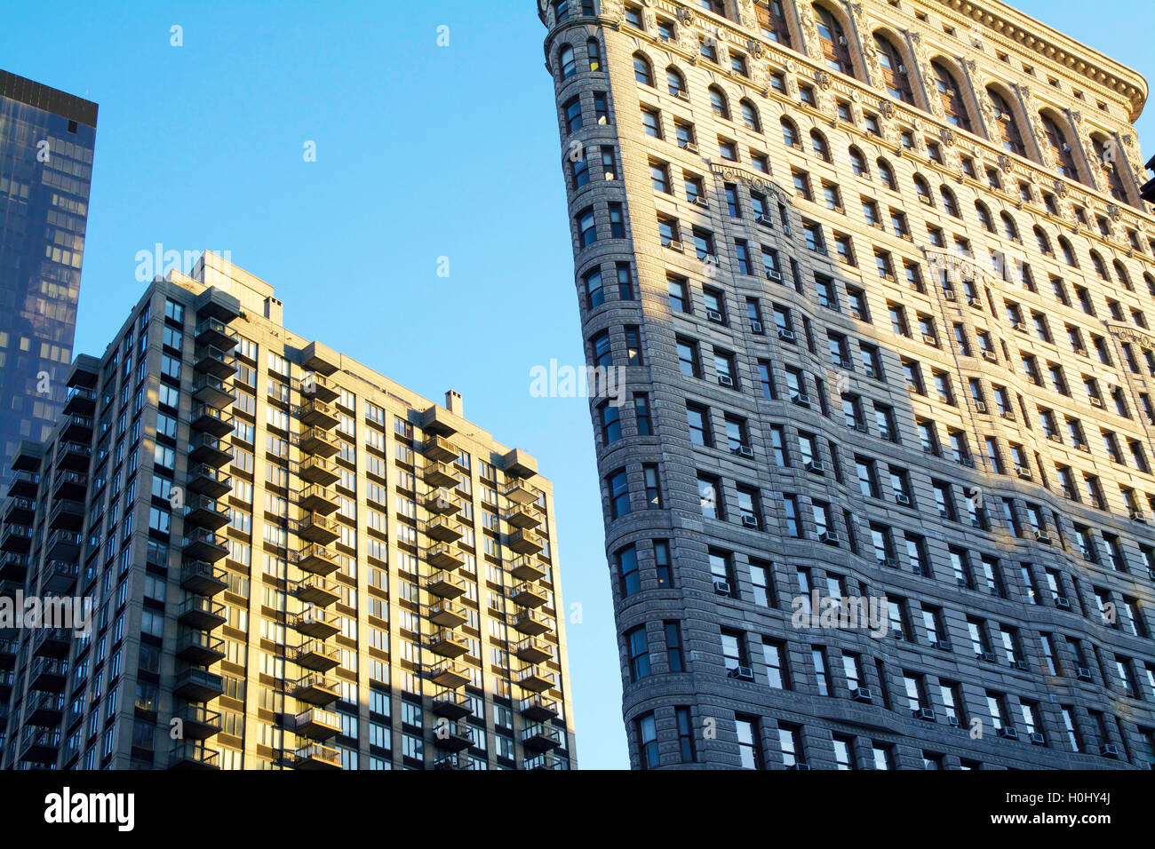 Dramatic Angled Front Facade of Flatiron Building with Sunrise in Manhattan, New York City, NY, USA. Elevation Shot. Stock Photo