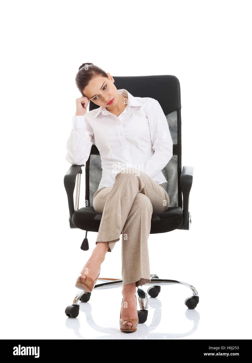 Beautiful sand business woman sitting on a chair. Stock Photo