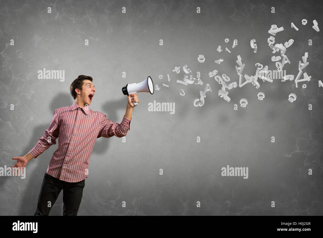 Portrait of a young man shouting using megaphone Stock Photo - Alamy