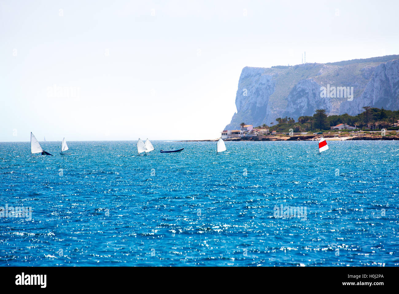Sailboats Optimist learning to sail in Mediterranean at Denia Stock