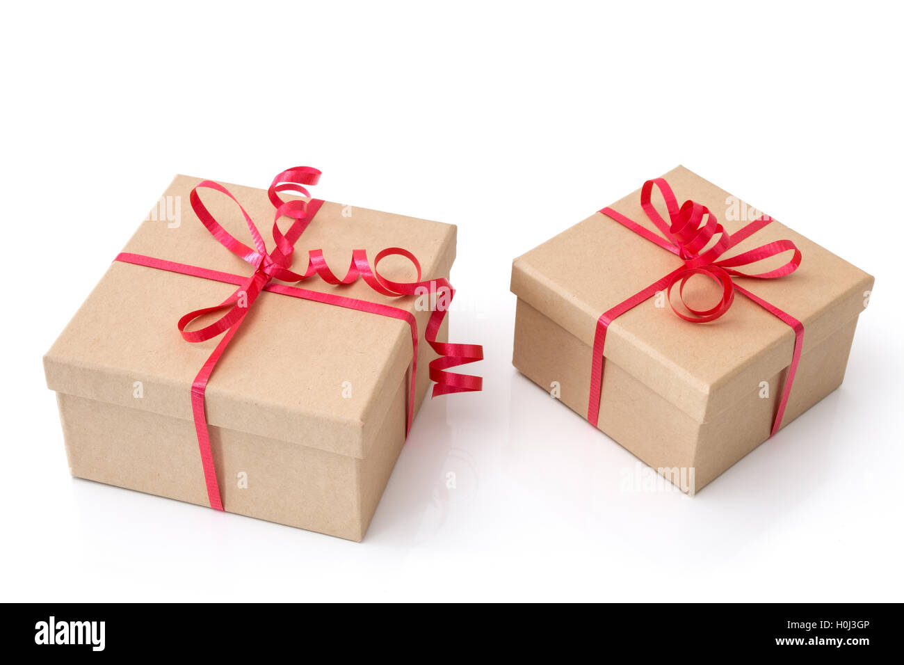 Two gift boxes with red ribbons on white background Stock Photo Alamy