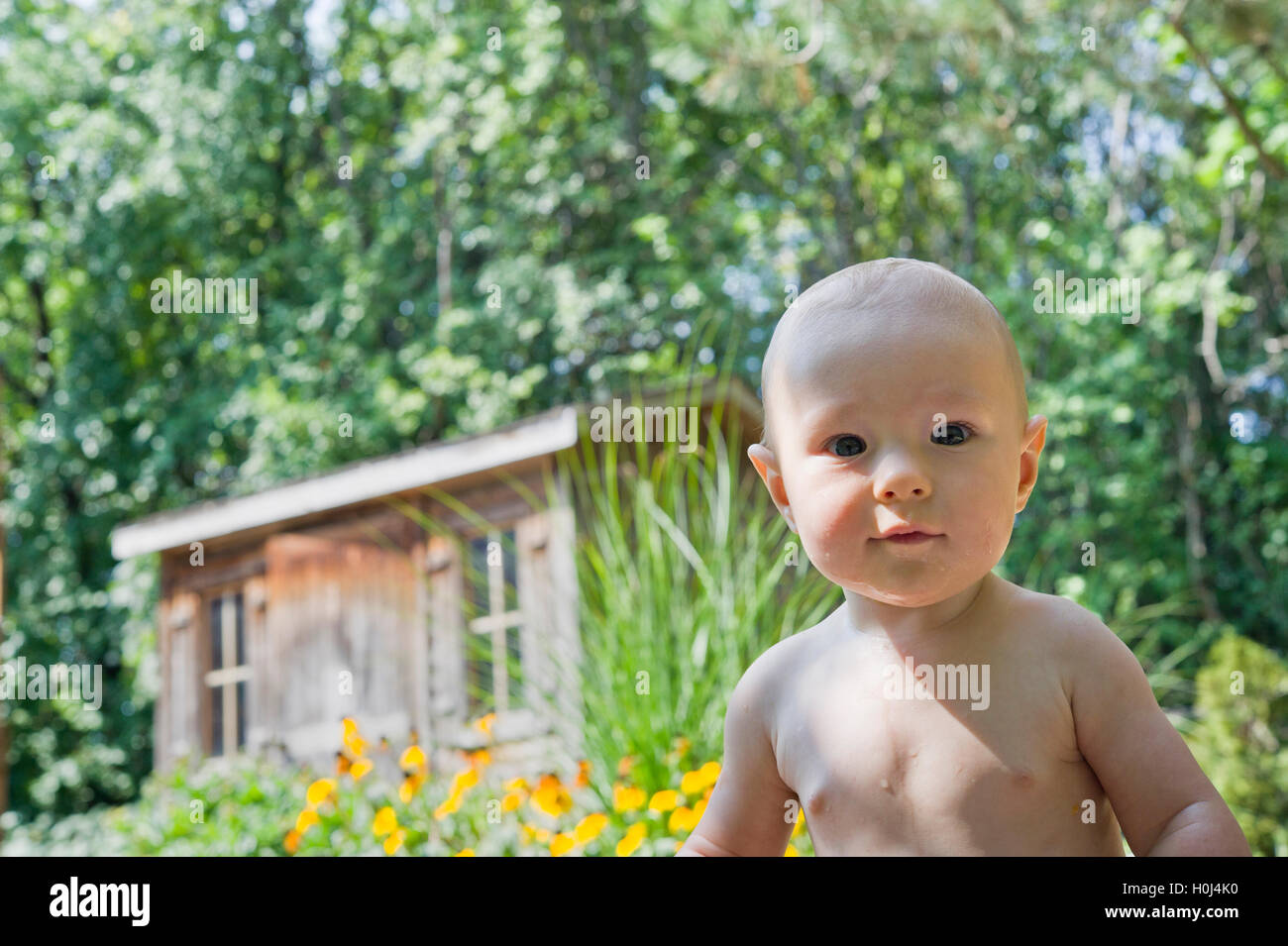 infant boy bathing in a backyard Stock Photo