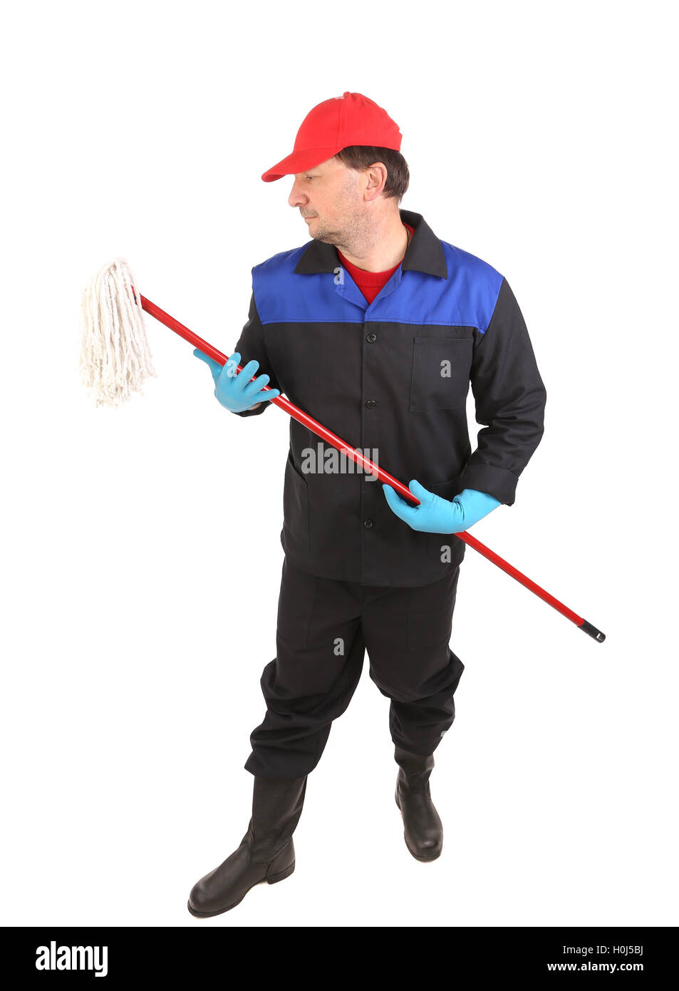 Man in workwear with mop. Stock Photo