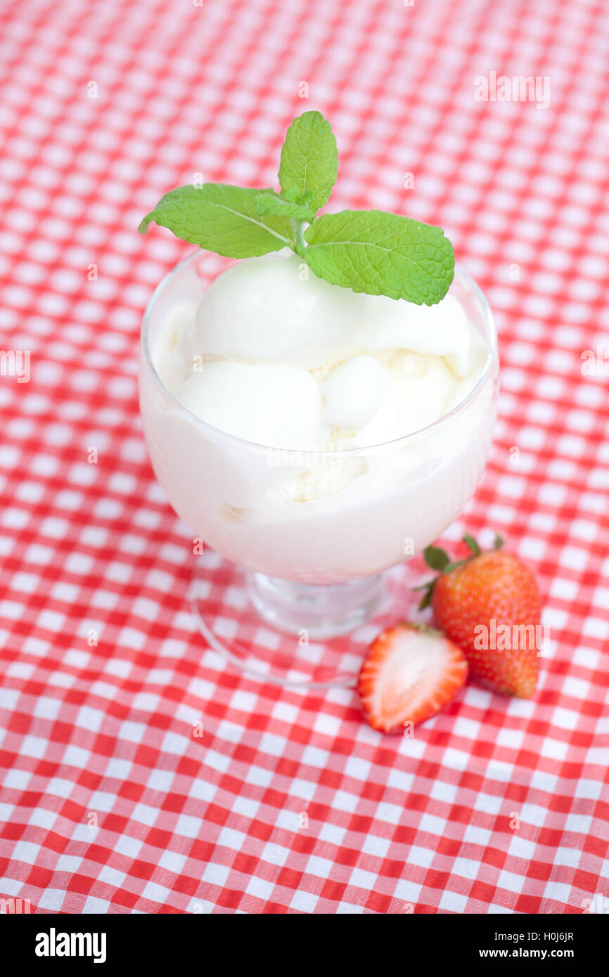 ice cream with mint in a glass bowl and strawberry on plaid fabr Stock ...