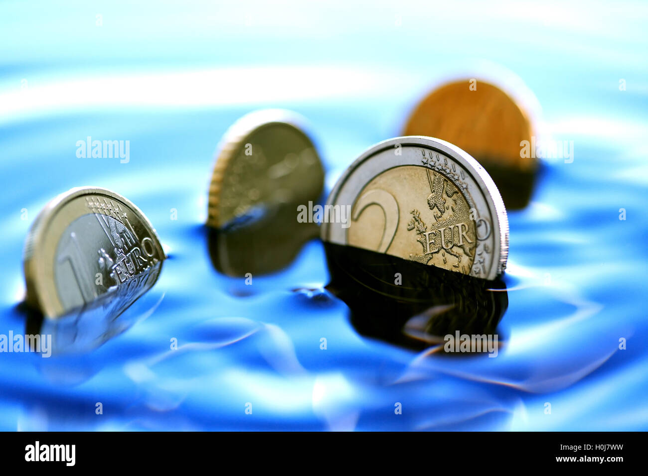 Sinking Coins Stock Photo